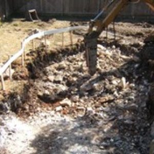 a bulldozer digging in a backyard
