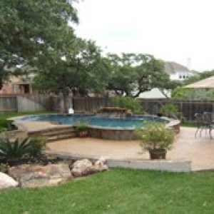 backyard with an above ground stone pool