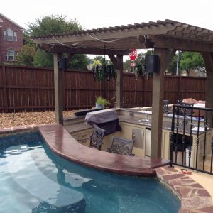 outdoor kitchen next to a pool