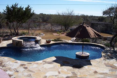 swimming pool with a hot tub and an umbrella bar