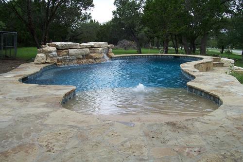 fountain and a water fall in a pool