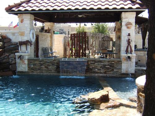 pool with a fence and waterfall