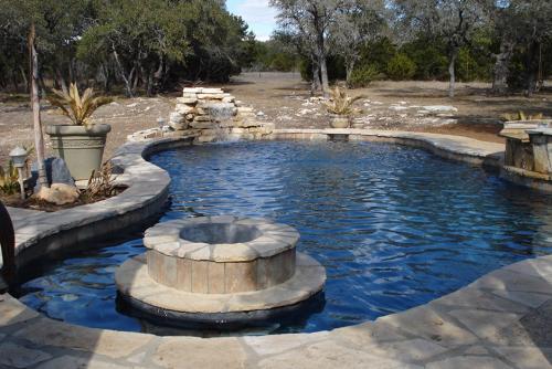 pool with a fountain and intricate stone work