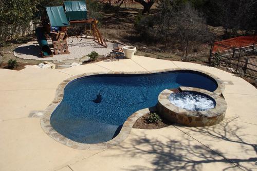 swimming pool surrounded by cement path